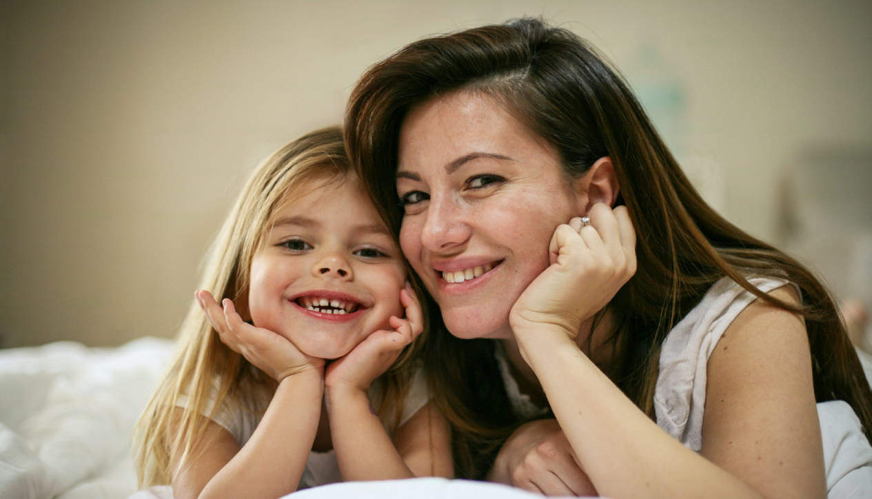 Mother and daughter smiling